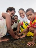 Participating in a National Youth Council of Fiji mangrove-planting project to address the shoreline erosion that has resulted from rising sea-levels